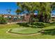 Community putting green near the pool area, surrounded by lush green grass and mature trees at 7009 E Acoma Dr # 1046, Scottsdale, AZ 85254