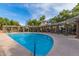 Resort-style swimming pool surrounded by lush landscaping and shaded seating areas for relaxation at 7009 E Acoma Dr # 1046, Scottsdale, AZ 85254