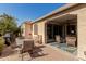 Charming outdoor living area with a covered patio, dining table, and a grill, ideal for entertaining at 815 E Laddoos Ave, San Tan Valley, AZ 85140