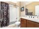 Bathroom featuring a shower-tub combo and a brown vanity at 815 E Laddoos Ave, San Tan Valley, AZ 85140