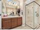 Bathroom with a tiled shower, decorative mirror, and a neutral colored vanity at 815 E Laddoos Ave, San Tan Valley, AZ 85140