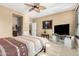 Bedroom featuring a ceiling fan, carpet flooring and a tv on a white console table at 815 E Laddoos Ave, San Tan Valley, AZ 85140