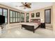 Bedroom with a ceiling fan, carpet flooring and multiple windows with wood shutters at 815 E Laddoos Ave, San Tan Valley, AZ 85140