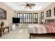 Bedroom with a ceiling fan, carpet flooring and multiple windows with wood shutters at 815 E Laddoos Ave, San Tan Valley, AZ 85140