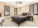 Bedroom with a ceiling fan, carpet flooring and multiple windows with wood shutters at 815 E Laddoos Ave, San Tan Valley, AZ 85140