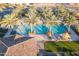 Aerial view of a community pool area showcasing palm trees, lounge seating and a tiled building at 815 E Laddoos Ave, San Tan Valley, AZ 85140