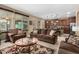 Open-concept living room with a view of the kitchen, hardwood floors and natural light at 815 E Laddoos Ave, San Tan Valley, AZ 85140