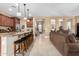 Open floor plan connecting the kitchen and living room, featuring neutral paint, tile floors and natural lighting at 815 E Laddoos Ave, San Tan Valley, AZ 85140