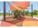 Colorful community playground featuring slides, climbing structures, and shaded seating for families to enjoy at 815 E Laddoos Ave, San Tan Valley, AZ 85140