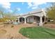 Backyard view featuring an outdoor kitchen, manicured lawn, and a refreshing pool, perfect for relaxing outdoors at 8214 E Kael St, Mesa, AZ 85207