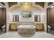 Spa-like bathroom with dual vanities, soaking tub, and decorative mosaic tile at 8214 E Kael St, Mesa, AZ 85207