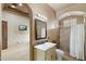 Bathroom with a shower, vanity, mirror, and a view into a bedroom at 8214 E Kael St, Mesa, AZ 85207