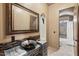 Unique bathroom with a decorative sink, a large mirror, and tiled accents at 8214 E Kael St, Mesa, AZ 85207