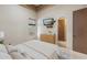 Bedroom showcasing a window with blinds, a TV, and a door to a bathroom at 8214 E Kael St, Mesa, AZ 85207