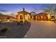 Stunning desert estate featuring stone accents, porte-cochere, lush desert landscaping and a circular driveway at 8214 E Kael St, Mesa, AZ 85207