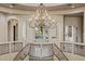 Spacious foyer features a decorative chandelier, circular balcony and neutral color palette at 8214 E Kael St, Mesa, AZ 85207