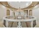 Spacious foyer features a decorative chandelier, circular balcony and neutral color palette at 8214 E Kael St, Mesa, AZ 85207