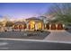 Elegant home exterior with lush landscaping, decorative lighting, and a circular driveway for added convenience at 8214 E Kael St, Mesa, AZ 85207