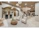 Open-concept living room with a bar, staircase, and tiled floors at 8214 E Kael St, Mesa, AZ 85207