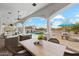 Relaxing poolside view showcasing the pool, spa, and covered seating with ample space for entertaining guests at 8214 E Kael St, Mesa, AZ 85207