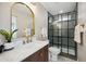 This bathroom features a sleek vanity and arch mirror adjacent to the shower with herringbone tile at 8432 E Keim Dr, Scottsdale, AZ 85250