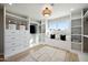 Spacious walk-in closet with built-in shelving and seating with a bright window for natural light at 8432 E Keim Dr, Scottsdale, AZ 85250