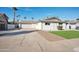 Charming single-story home with a spacious driveway, white paint, and a well-maintained front yard at 8432 E Keim Dr, Scottsdale, AZ 85250