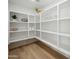 Well-organized pantry with ample shelving, providing storage for various household goods and décor at 8432 E Keim Dr, Scottsdale, AZ 85250