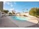 Backyard featuring a refreshing pool, mature trees, and a privacy fence with a seating area at 8432 E Keim Dr, Scottsdale, AZ 85250