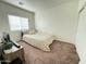 Bedroom featuring a tan carpet and a cozy bed by the window at 8477 W Tinajas Dr, Arizona City, AZ 85123