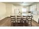 Bright kitchen featuring an island with barstool seating, white cabinets, subway tile backsplash, and modern appliances at 8477 W Tinajas Dr, Arizona City, AZ 85123