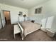 Bright and airy bedroom with a large bed, bench, and neutral color scheme, creating a calming retreat at 8477 W Tinajas Dr, Arizona City, AZ 85123