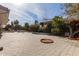 Landscaped backyard with a mature tree and unique brickwork at 8544 E San Lorenzo Dr, Scottsdale, AZ 85258