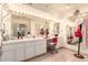 Well-lit bathroom vanity featuring double sinks and a vanity mirror with Hollywood lighting at 8544 E San Lorenzo Dr, Scottsdale, AZ 85258