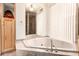 Large soaking tub surrounded by marble, with a separate shower and built-in storage at 8544 E San Lorenzo Dr, Scottsdale, AZ 85258