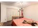 Neutral bedroom features a ceiling fan, double closets and wood floors at 8544 E San Lorenzo Dr, Scottsdale, AZ 85258