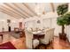 Bright dining room with elegant chandelier, exposed beam ceiling and hardwood floors at 8544 E San Lorenzo Dr, Scottsdale, AZ 85258