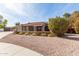 Single-story home with a red tile roof, front porch, desert landscaping, and spacious driveway at 8544 E San Lorenzo Dr, Scottsdale, AZ 85258