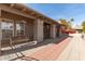 Inviting front porch featuring a seating bench, flower baskets, and a tiled walkway to the front door at 8544 E San Lorenzo Dr, Scottsdale, AZ 85258