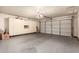 Spacious garage with ample storage cabinets, a clean epoxy floor and an automatic door at 8544 E San Lorenzo Dr, Scottsdale, AZ 85258