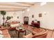 Charming living room featuring exposed beam ceiling, hardwood floors and ample space for entertaining at 8544 E San Lorenzo Dr, Scottsdale, AZ 85258