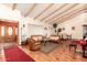 Elegant living room featuring exposed beam ceiling, hardwood floors and comfortable seating area at 8544 E San Lorenzo Dr, Scottsdale, AZ 85258