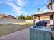 A spacious backyard includes a covered patio, a barbecue, and an air conditioning unit at 8926 W Lockland Ct, Peoria, AZ 85382