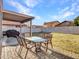 A spacious backyard features a covered patio, a table and chairs, and a brick-lined walkway at 8926 W Lockland Ct, Peoria, AZ 85382