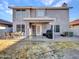 A two story home features a spacious backyard with a covered patio, a table and chairs, and a barbecue at 8926 W Lockland Ct, Peoria, AZ 85382