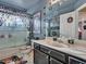 Fun bathroom featuring decorative sugar skulls, a glass shower door and vanity with drawers and a single sink at 8926 W Lockland Ct, Peoria, AZ 85382