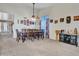 Open-concept dining area features a large table, natural lighting, and neutral wall paint at 8926 W Lockland Ct, Peoria, AZ 85382