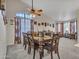 Spacious dining room with a large wooden table, decorative ceiling fan, and view to sitting room at 8926 W Lockland Ct, Peoria, AZ 85382