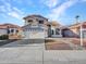 Inviting home with a well-maintained front yard, two-car garage, desert landscaping, and a neutral color palette at 8926 W Lockland Ct, Peoria, AZ 85382