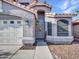 Close-up of the front entrance showing desert landscaping, front door with security screen, and house number at 8926 W Lockland Ct, Peoria, AZ 85382